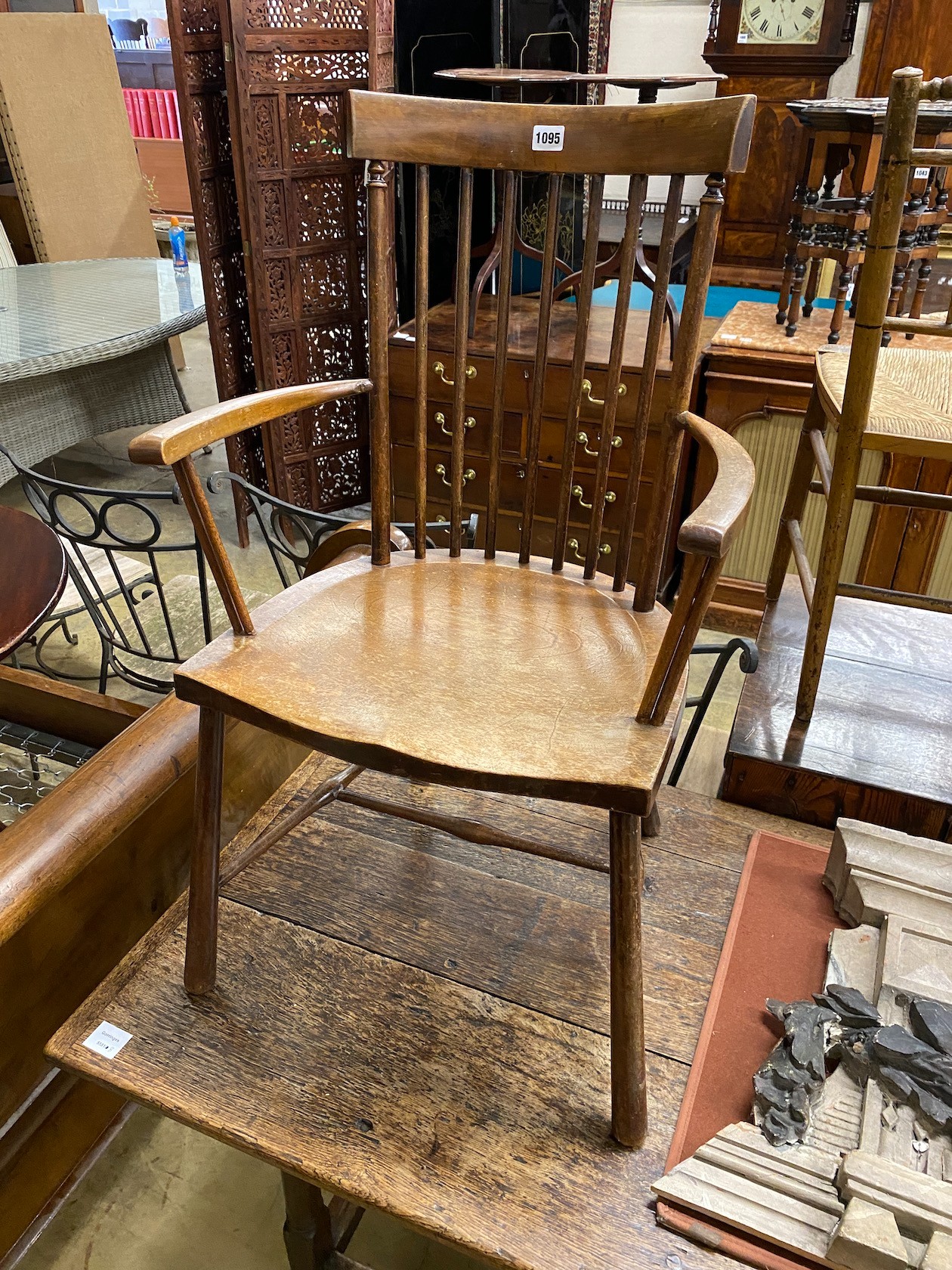 An early 20th century beech Windsor comb back elbow chair, width 49cm, depth 41cm, height 86cm